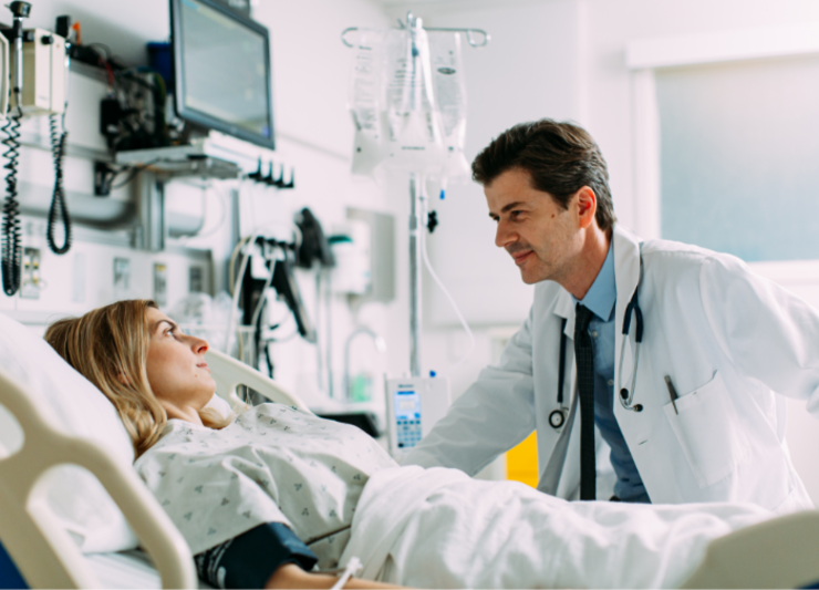 Doctor speaking to a patient in bed